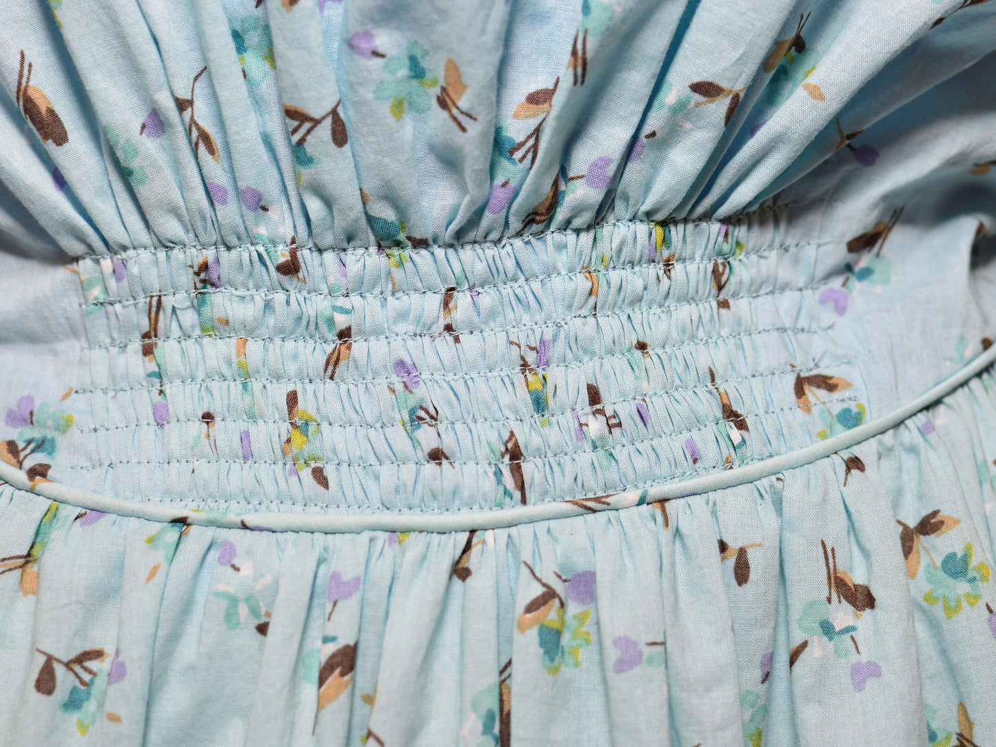 A close-up shows the ruching and piping at the waist of a Victorian fan dress