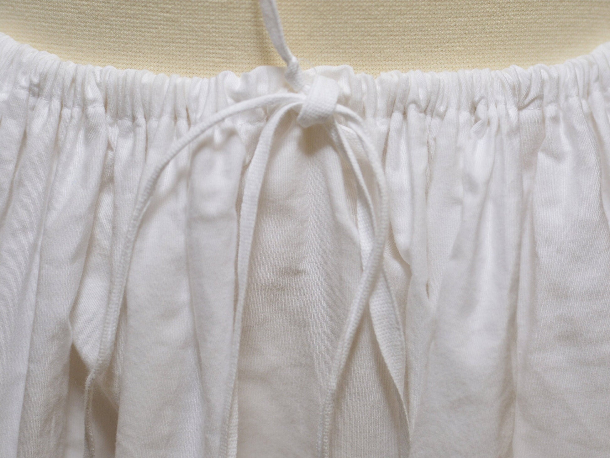 A close-up shows the drawstring waist of a Victorian petticoat