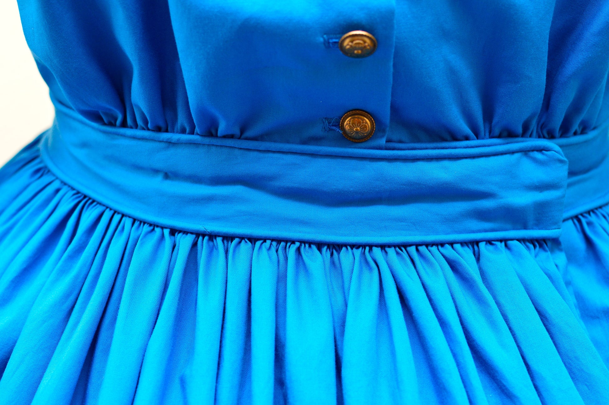 A close-up photo shows the waistband of an 1860s dress and a closed dog-leg