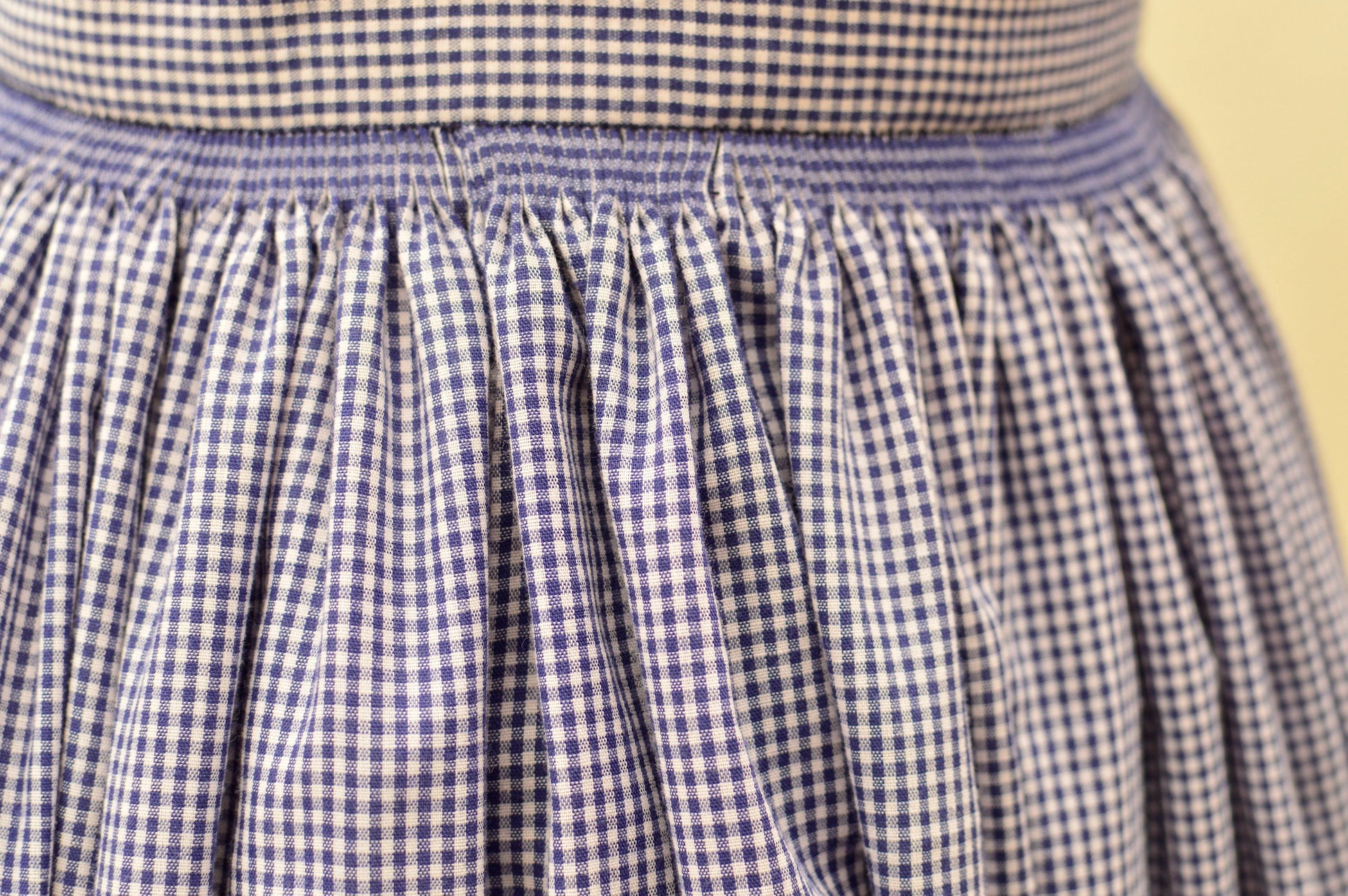 a close-up photo of a full skirt cartridge-pleated to a waistband.